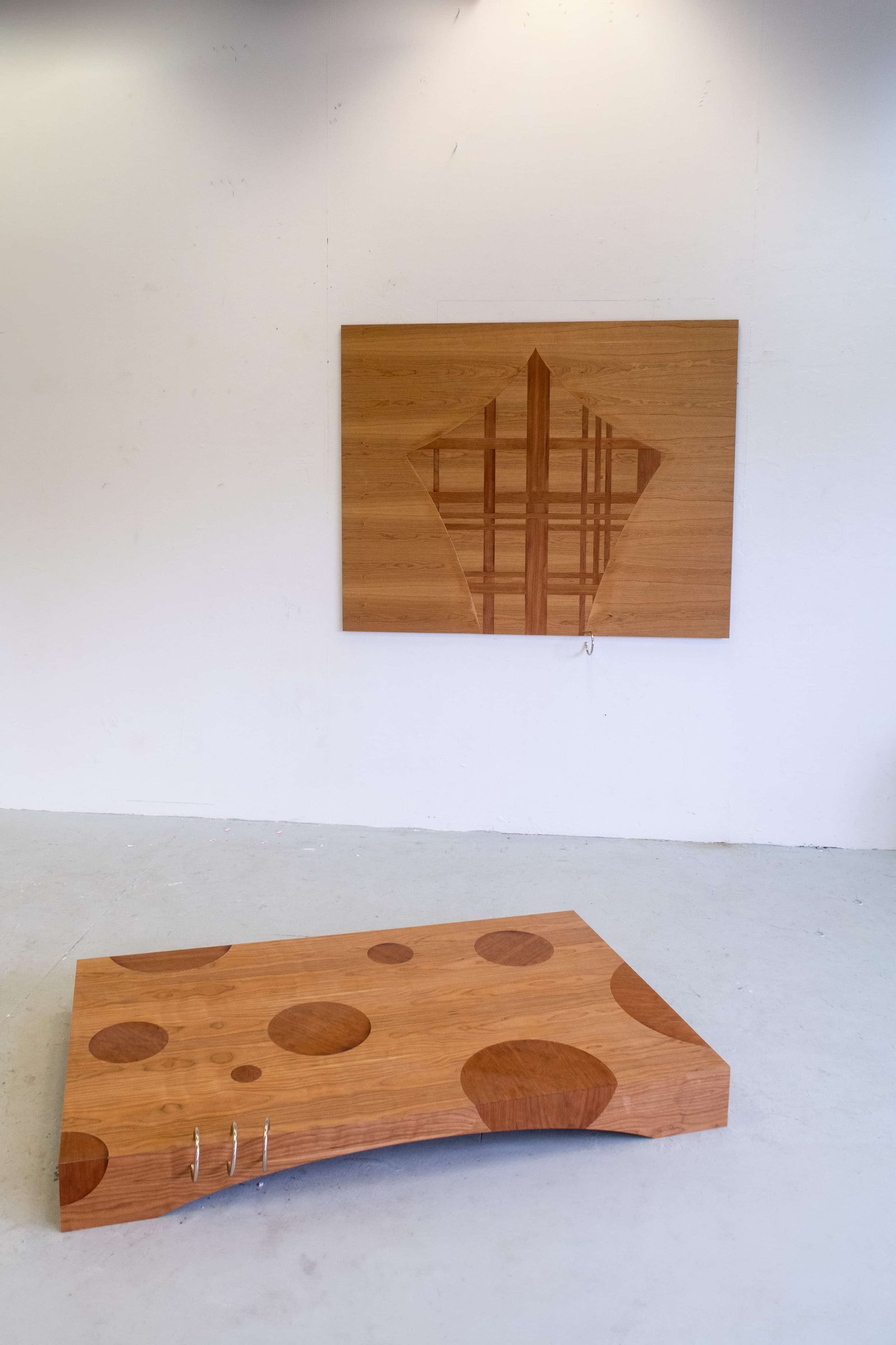 Fi Isidore, Lapel Snare: Platform & Lapel Snare: Curtain Call,  2024, Sand shaded marquetry in cherry veneer with aluminium piercings